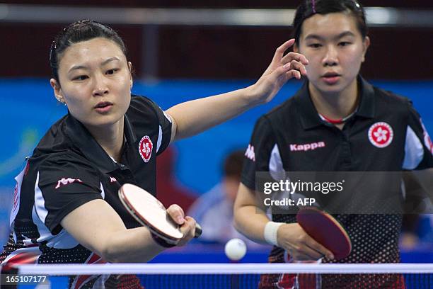 Jiang Huajun of Hong Kong returns a shot next to her teammate Lee Ho Ching, to Liu Shiwen and Ding Ning of China during the World Team Classic Table...