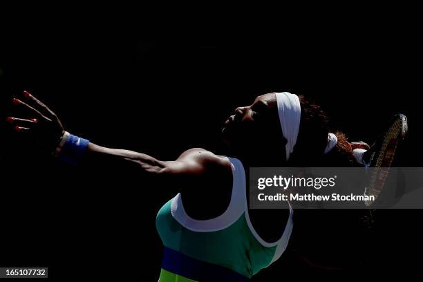 Serena Williams serves to Maria Sharapova of Russia during the final of the Sony Open at Crandon Park Tennis Center on March 30, 2013 in Key...