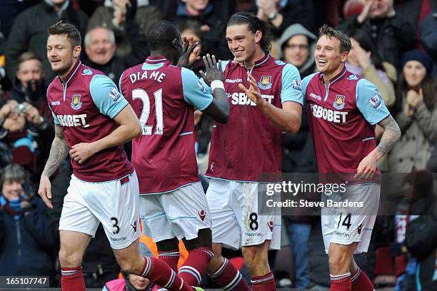 Andy Carroll of West Ham United celebrates scoring his second goal and his team's third with teammates Mohamed Diame and Matthew Taylor during the...