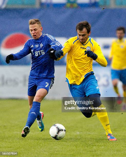 Balazs Dzsudzsak of FC Dynamo Moscow is challenged by Danko Lazovic of FC Rostov Rostov-on-Don during the Russian Premier League match between FC...