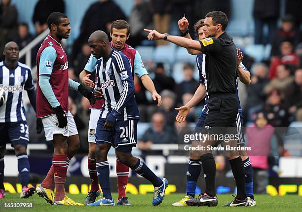 Youssouf Mulumbu of West Bromwich Albion is sent off by referee Andre Marriner during the Barclays Premier League match between West Ham United and...