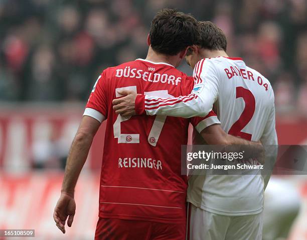 Stefan Reisinger of Duesseldorf and Daniel Schwaab of Leverkusen walk arm in arm after the Bundesliga match between Fortuna Duesseldorf and Bayer...