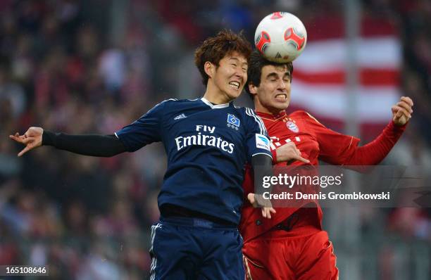 Javi Martinez of Bayern Muenchen wins a header against Heung Min Son of Hamburger SV during the Bundesliga match between FC Bayern Muenchen and...