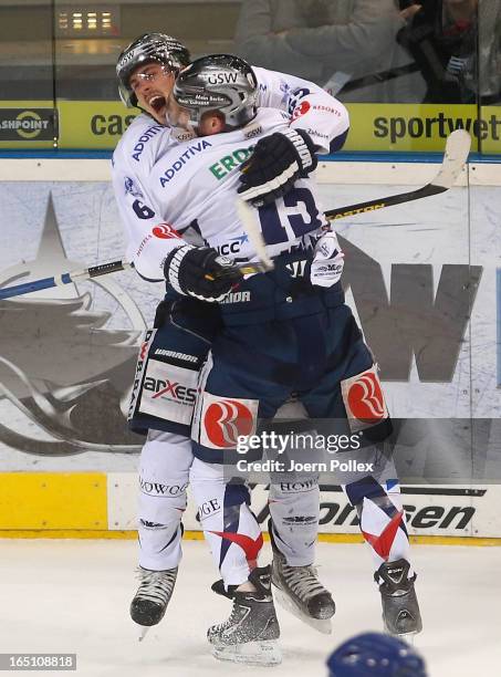 Tyson Mulock of Berlin celebrates with his team mate Travis James Mulock after scoring his team's third goal during game six of the DEL play-offs...