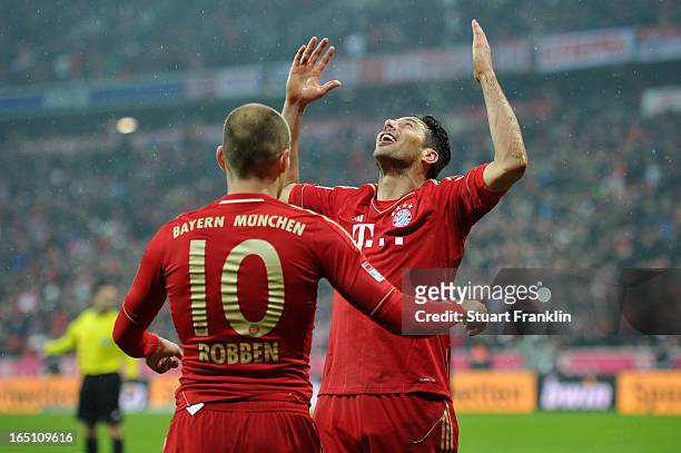 Claudio Pizarro of Bayern Muenchen celebrates scoring his team's sixth goal with Arjen Robben during the Bundesliga match between FC Bayern Muenchen...
