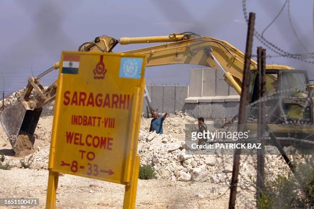An Israeli excavator works along the Lebanese-Israeli borders near a position of Indian peacekeepers with the United Nations Interim Forces in the...