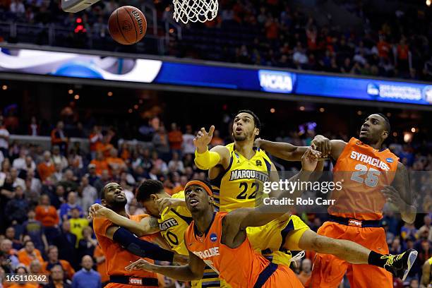 Fair of the Syracuse Orange and Rakeem Christmas of the Syracuse Orange fight for the rebound against Trent Lockett of the Marquette Golden Eagles...