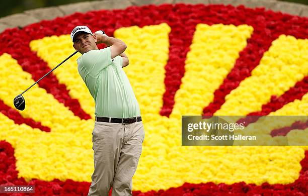 Bill Haas watches his tee shot on the 18th hole during the third round of the Shell Houston Open at the Redstone Golf Club on March 30, 2013 in...