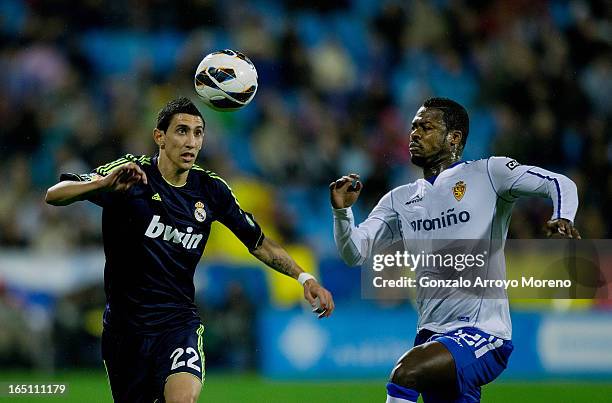 Angel Di Maria of Real Madrid CF competes for the ball with Christian Romaric of Real Zaragoza during the La Liga match between Real Zaragoza and...