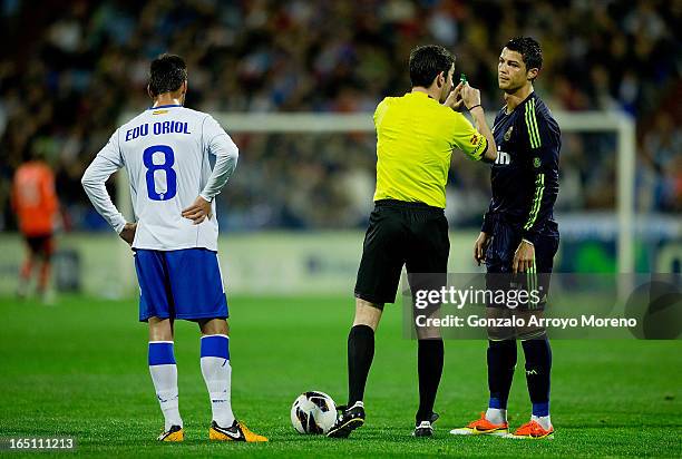 Referee Undiano Mallenco tells Cristiano Ronaldo of Real Madrid CF to wait for the whistle before taking his penalty as Edu Oriol of Real Zaragoza...