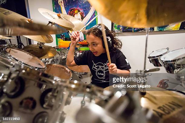 Guinness Book of World Records for Worlds Youngest Drummer, Julian Pavone, aged 8, sits in during a photo session at Julian Pavone Studio on March...