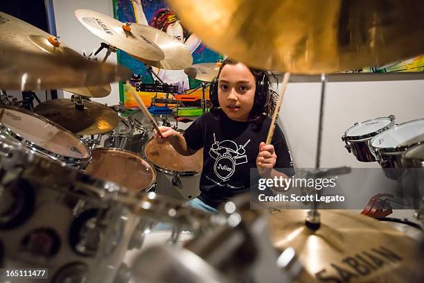 Guinness Book of World Records for Worlds Youngest Drummer, Julian Pavone, aged 8, sits in during a photo session at Julian Pavone Studio on March...