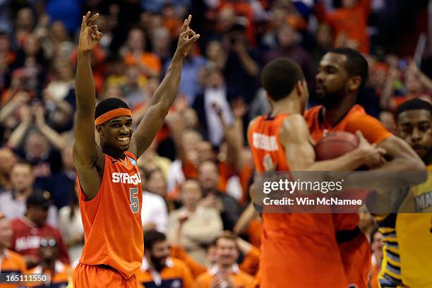Fair of the Syracuse Orange celebrates after defeating the Marquette Golden Eagles to win the East Regional Round Final of the 2013 NCAA Men's...