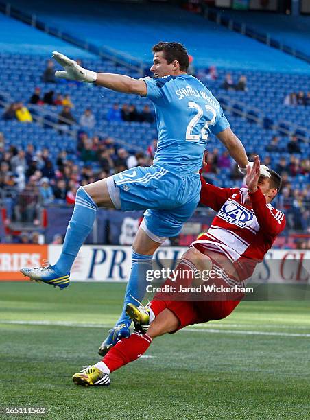 Bobby Shuttleworth of New England Revolution collides with Kenny Cooper of FC Dallas while making a save on the ball during the game at Gillette...