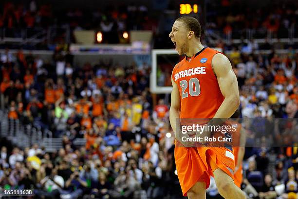 Brandon Triche of the Syracuse Orange reacts towards the end of the game against the Marquette Golden Eagles during the East Regional Round Final of...