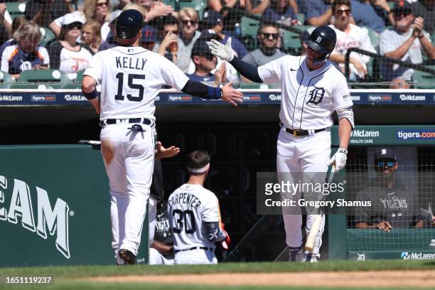 Carson Kelly of the Detroit Tigers celebrates scoring a run in the fifth inning with Spencer Torkelson while playing the New York Yankees at Comerica...