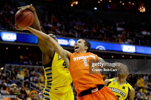 Michael Carter-Williams of the Syracuse Orange draws contact against Chris Otule of the Marquette Golden Eagles during the East Regional Round Final...