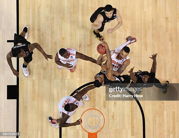 LaQuinton Ross of the Ohio State Buckeyes goes up for a shot against Carl Hall and Cleanthony Early of the Wichita State Shockers in the first half...