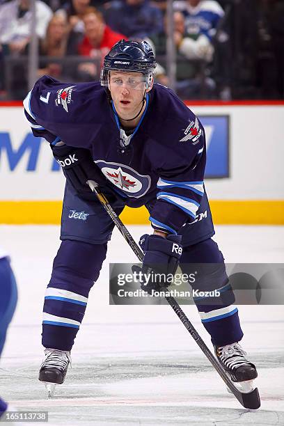 Derek Meech of the Winnipeg Jets gets set for a third period face-off against the Tampa Bay Lightning at the MTS Centre on March 24, 2013 in...