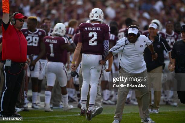 Head Coach Kevin Sumlin congratulates QB Johnny Manziel during a game against the Alabama Crimson Tide at Kyle Field on September 14, 2013 in College...