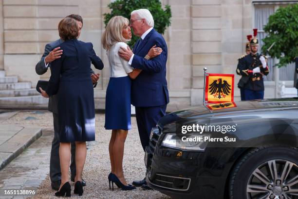 French President Emmanuel Macron and his wife Brigitte Macron greet German President Frank-Walter Steinmeier and his wife Elke Buedenbender at Elysee...