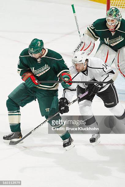 Brett Clark of the Minnesota Wild battles for the puck with Justin Williams of the Los Angeles Kings during the game on March 30, 2013 at the Xcel...