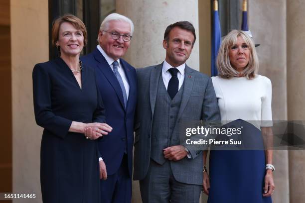 French President Emmanuel Macron and his wife Brigitte Macron greet German President Frank-Walter Steinmeier and his wife Elke Buedenbender at Elysee...