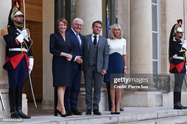 French President Emmanuel Macron and his wife Brigitte Macron greet German President Frank-Walter Steinmeier and his wife Elke Buedenbender at Elysee...