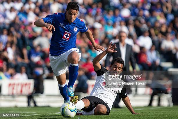 Pablo Barrera of Cruz Azul fights for the ball with Carlos Gutierrez of Atlas during a match between Cruz Azul and Atlas as part of the Clausura 2013...