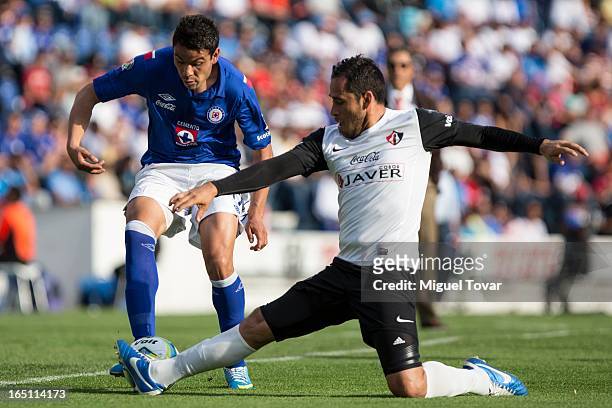 Pablo Barrera of Cruz Azul fights for the ball with Oscar Razo of Atlas during a match between Cruz Azul and Atlas as part of the Clausura 2013 at...