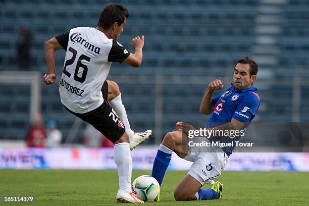 Alejandro Castro of Cruz Azul fights for the ball with Carlos Gutierrez of Atlas during a match between Cruz Azul and Atlas as part of the Clausura...