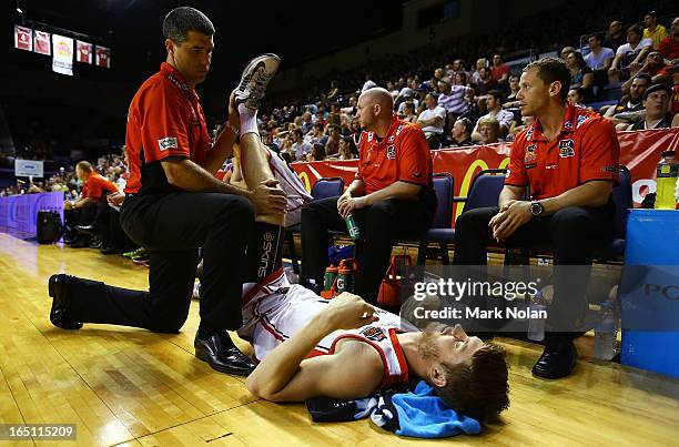 Cameron Tovey of the Wildcats receives attention during game two of the NBL Semi Final series between the Wollongong Hawks and the Perth Wildcats at...