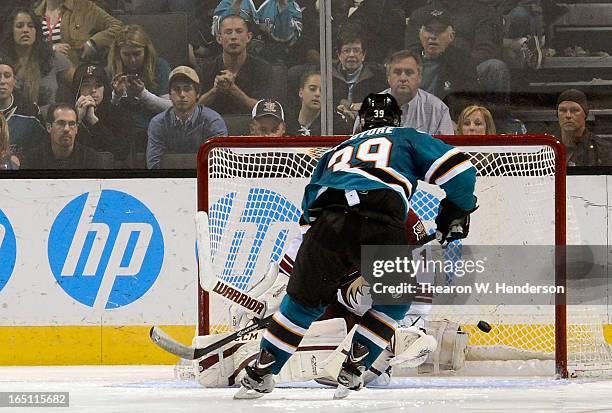 Logan Couture of the San Jose Sharks scores getting his shot past goalkeeper Jason LaBarbera of the Phoenix Coyotes in an overtime shoot-out at HP...