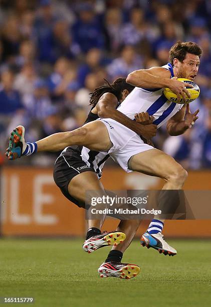 Harry O'Brien of the Magpies tackles Sam Gibson of the Kangaroos during the round one AFL match between the North Melbourne Kangaroos and Collingwood...