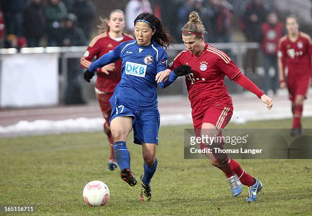 Yuki Ogimi of Potsdam challenges Amber Brooks of Munich during the Women's Soccer Bundesliga Match between Bayern Muenchen and 1. FFC Turbine Potsdam...
