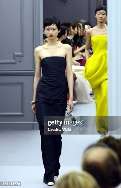 Model showcases designs on the catwalk during the Christian Dior S/S 2013 Haute Couture Collection at Five on the Bund on March 30, 2013 in Shanghai,...