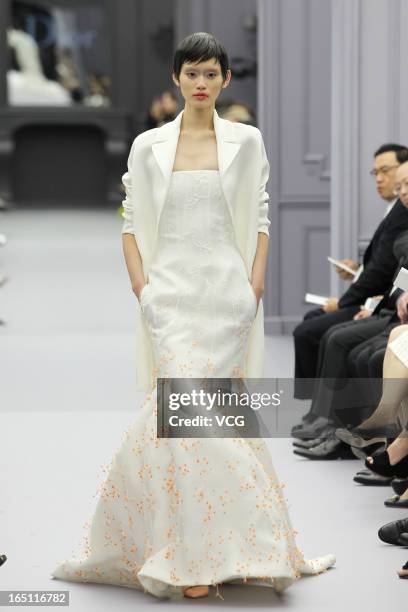 Model showcases designs on the catwalk during the Christian Dior S/S 2013 Haute Couture Collection at Five on the Bund on March 30, 2013 in Shanghai,...