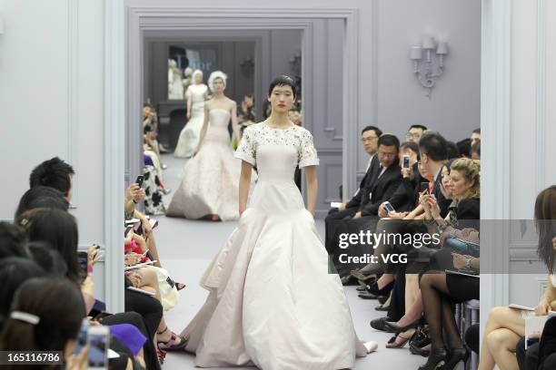 Model showcases designs on the catwalk during the Christian Dior S/S 2013 Haute Couture Collection at Five on the Bund on March 30, 2013 in Shanghai,...