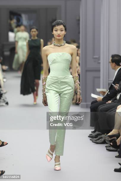 Model showcases designs on the catwalk during the Christian Dior S/S 2013 Haute Couture Collection at Five on the Bund on March 30, 2013 in Shanghai,...