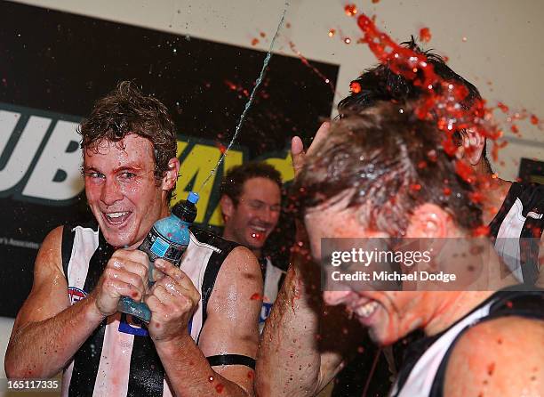 Sam Dwyer of the Magpies celebrates the win with Josh Thomas during the round one AFL match between the North Melbourne Kangaroos and Collingwood...