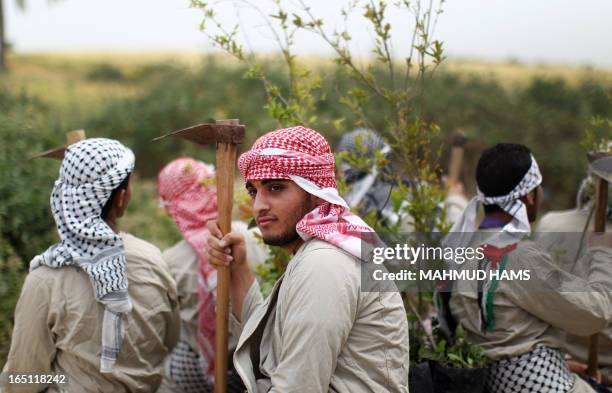 Palestinians dressed up as farmers take part in a rally marking Land Day in Beit Hanun in the northern Gaza Strip close to the border with Israel on...