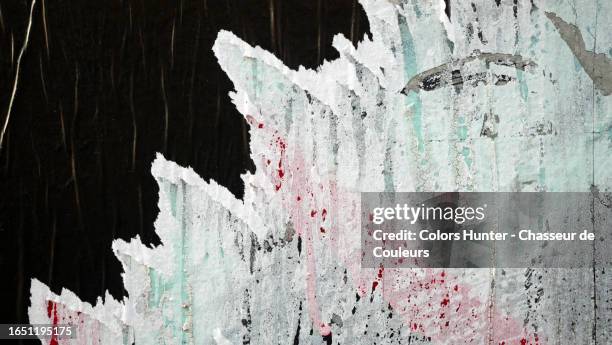 close-up of a empty black poster, stuck and torn on a wall in paris, france - torn newspaper stock pictures, royalty-free photos & images