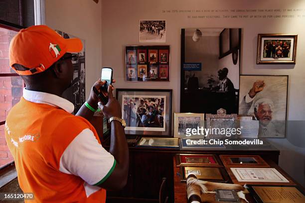 Tourist takes a photograph inside the Mandela House and Museum on historic Vilakazi Street in Soweto March 31, 2013 in Johannesburg, South Africa....
