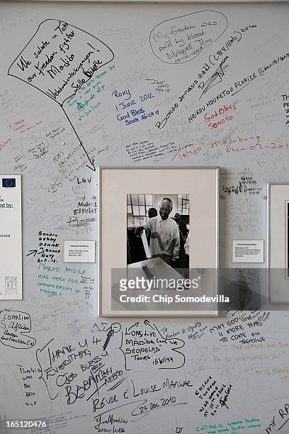 Messages of honor and support are written on the wall around a photograph of former South African President Nelson Mandela at Regina Mundi Catholic...