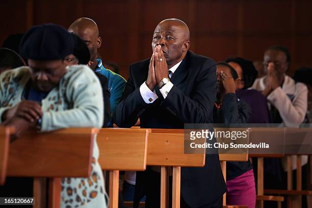 Congregants pray during Easter services at Regina Mundi Catholic Church in the Soweto area March 31, 2013 in Johannesburg, South Africa. A central...