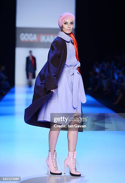 Model walks the runway at the Goga Nikabadze show during Mercedes-Benz Fashion Week Russia Fall/Winter 2013/2014 at Manege on March 31, 2013 in...