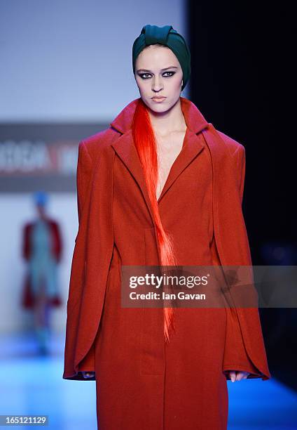 Model walks the runway at the Goga Nikabadze show during Mercedes-Benz Fashion Week Russia Fall/Winter 2013/2014 at Manege on March 31, 2013 in...