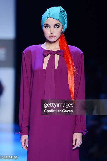 Model walks the runway at the Goga Nikabadze show during Mercedes-Benz Fashion Week Russia Fall/Winter 2013/2014 at Manege on March 31, 2013 in...