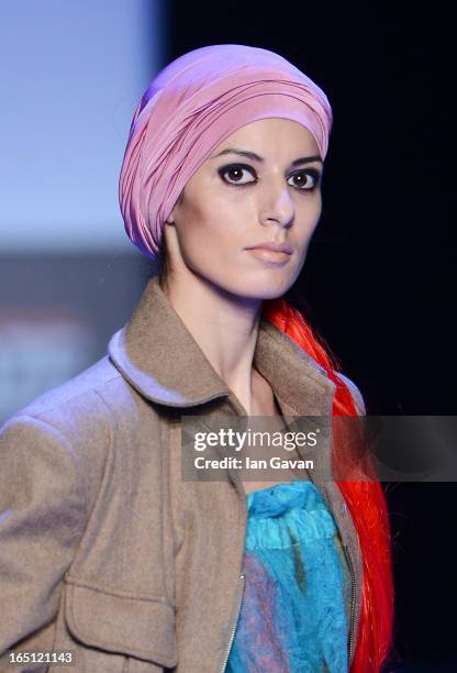 Model walks the runway at the Goga Nikabadze show during Mercedes-Benz Fashion Week Russia Fall/Winter 2013/2014 at Manege on March 31, 2013 in...