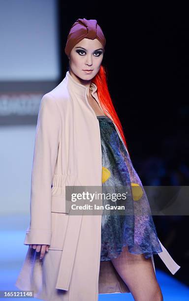 Model walks the runway at the Goga Nikabadze show during Mercedes-Benz Fashion Week Russia Fall/Winter 2013/2014 at Manege on March 31, 2013 in...
